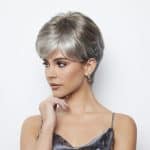 Stylish short silver wig on a woman with a modern look.