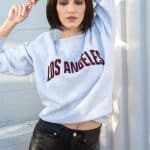 Fashion model with a sleek bob wig in a casual outfit for Hidden Secrets Wigs.