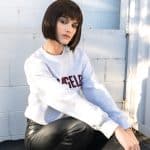 Fashion model with sleek bob wig in urban setting for Hidden Secrets Wigs.