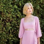 Blonde wig styled on a woman with a pink dress outdoors.
