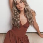Woman with long, wavy blonde wig from Hidden Secrets Wigs.