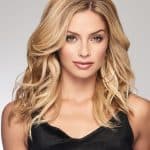 Blonde wavy wig styled on a woman for natural look and volume.