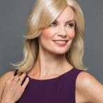 Blonde woman wearing a stylish blonde wig from Hidden Secrets Wigs.