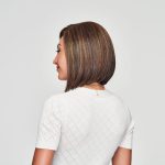 Side view of a woman with a sleek, straight bob wig in brown shades.