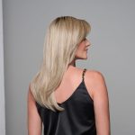 Blonde wig styled on a woman with side profile view.