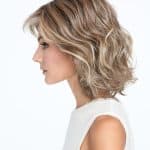 Blonde wavy wig styled on a woman with side profile view.