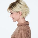Short blonde wig with layered texture on a smiling woman.