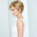 Elegant short blonde wig styled on a woman with side profile view.