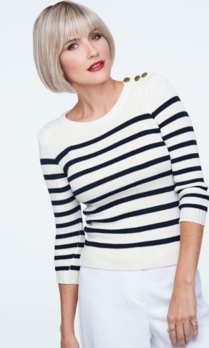 Blonde bob wig with side-swept bangs on a woman with light makeup.