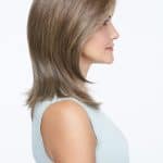 Side view of a woman wearing a natural blonde wig with layered style.