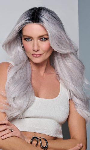 Woman with long silver ombre wavy wig and white tank top.