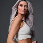 Woman with long silver hair and smoky eye makeup.