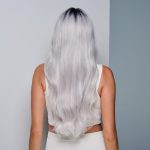 Woman with long, wavy silver wig seen from behind.