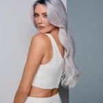 Elegant long silver wavy wig for women with side parting.