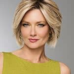 Elegant blonde wig on a woman with short layered hairstyle.