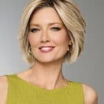 Elegant blonde bob wig showcased on a smiling woman with short hair.