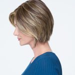 Short layered wig with blonde highlights and natural texture.