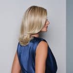 Blonde wavy wig styled on a woman with side profile view.