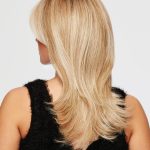 Blonde layered wig with soft waves for a natural look.