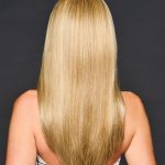 Long, straight blonde wig with shiny, smooth hair on a woman from the back.