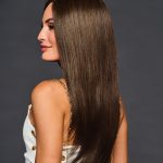 Beautiful woman with long, straight, brown wig showcasing silky hair.