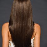 Long straight brown wig with a natural shine and smooth texture.