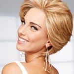 Beautiful woman with short blonde wig and stylish earrings.