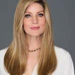 Beautiful blonde woman wearing Top Billing 18in wig from Hidden Secrets Wigs.