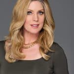 Blonde wavy wig with 14-inch length on a woman with blue eyes.