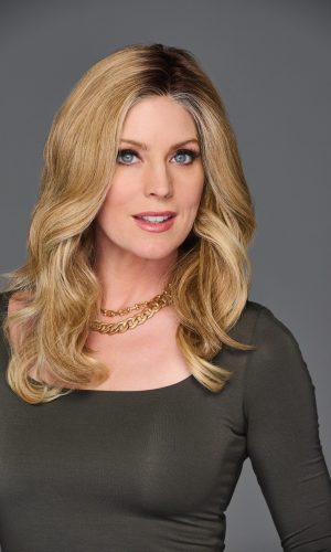 Blonde wavy wig with 14-inch length on a woman with blue eyes.