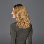 Wavy 14-inch wig on a woman with blonde hair, side view.