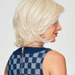 Blonde layered wig styled for a sophisticated look.