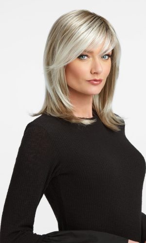 Blonde layered wig with side-swept bangs on a woman.
