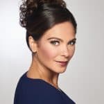 Beautiful woman with elegant curly updo wig for special occasions.