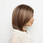 Side view of a woman with a sleek, straight brown bob wig.