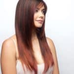 Long straight wig with rich auburn and chestnut highlights.