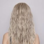 Blonde wavy wig from Hidden Secrets Wigs, Roxie style, on a model.
