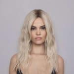 Blonde wavy wig model showcasing Roxie style from Hidden Secrets Wigs.