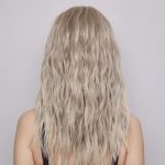 Blonde wavy wig showcased from behind, perfect for elegant styles.