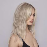 Blonde wavy wig on a model, perfect for elegant looks.