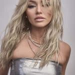 Blonde wavy wig model wearing Roxie from Alexander Couture Collection.