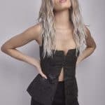Stylish woman with long, wavy blonde wig for elegant looks.
