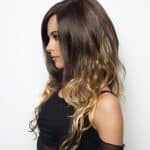 Long wavy wig with dark roots and blonde ends from Hidden Secrets Wigs.