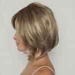 Blonde layered wig with side-swept bangs from Hidden Secrets Wigs.