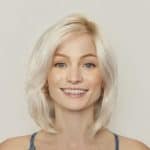 Blonde wig styled in a shoulder-length, wavy cut for a natural look.