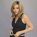 Blonde woman wearing Sophia wig from Alexander Couture Collection.