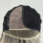 Close-up of wig cap showing lace front and mesh panels for natural look.