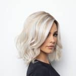 Blonde wavy wig styled for fashion, perfect for elegant looks.