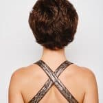 Short curly brown wig viewed from the back on a woman with crossed straps.