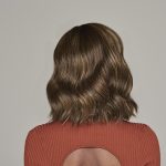 Wavy brown wig styled on a woman with shoulder-length hair.